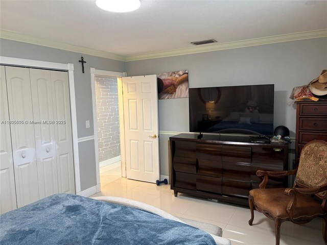 7430 Buchanan St, Hollywood, FL 33024 - bedroom with light tile patterned floors, crown molding, and a closet