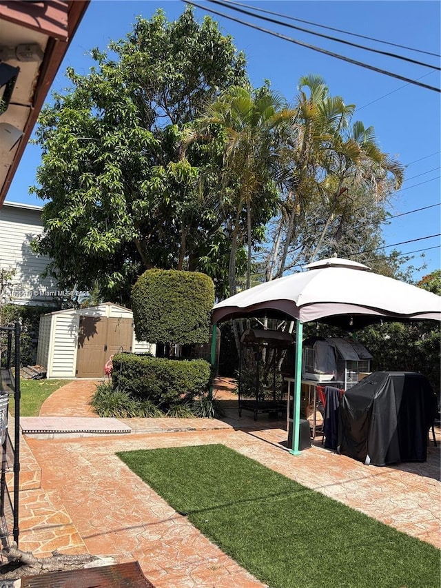 7430 Buchanan St, Hollywood, FL 33024 - view of yard featuring a storage shed and a patio