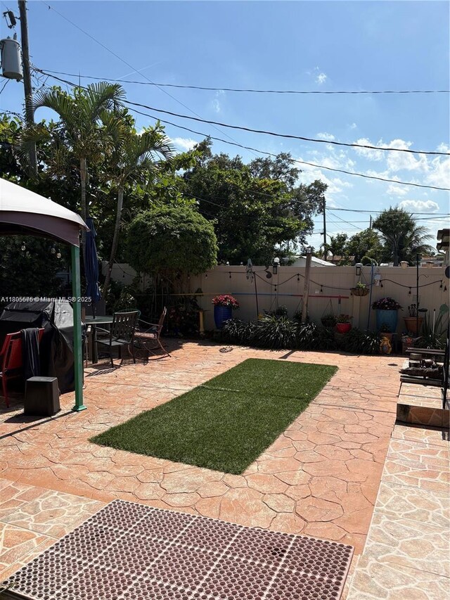 7430 Buchanan St, Hollywood, FL 33024 - view of yard with a patio area, a gazebo, and outdoor dining area