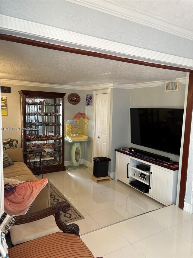 7430 Buchanan St, Hollywood, FL 33024 - living area featuring ornamental molding, light tile patterned floors, and a textured ceiling