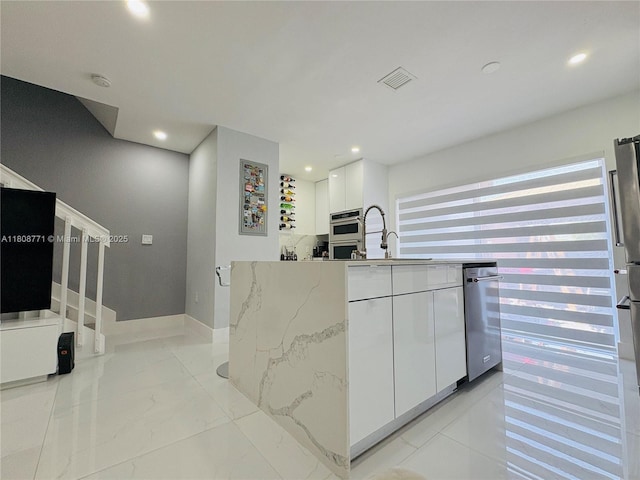13729 SW 171st Ln, Miami, FL 33177 - kitchen with white cabinets, light stone countertops, a sink, recessed lighting, and modern cabinets