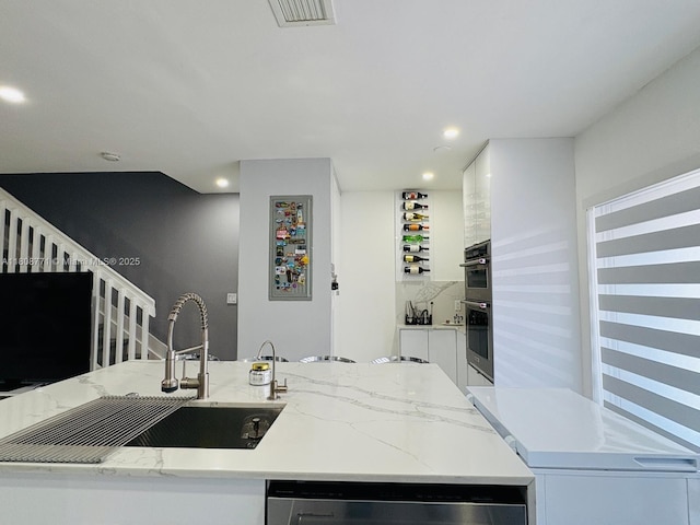 13729 SW 171st Ln, Miami, FL 33177 - kitchen featuring white cabinets, stainless steel appliances, light stone counters, recessed lighting, and a sink