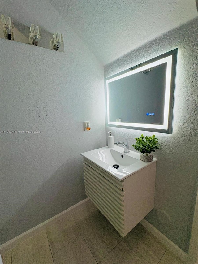 13729 SW 171st Ln, Miami, FL 33177 - bathroom featuring vanity, a textured wall, a textured ceiling, baseboards, and tile patterned floors