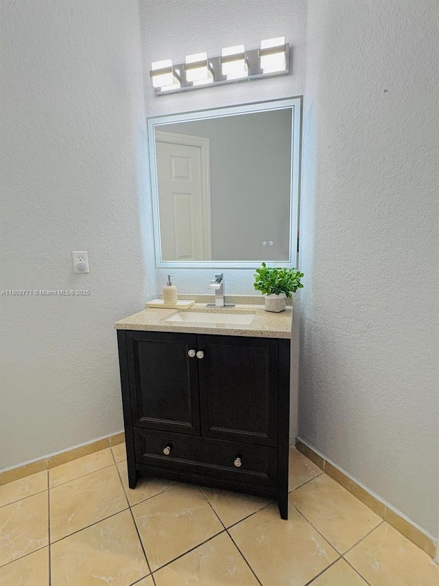13729 SW 171st Ln, Miami, FL 33177 - bathroom with vanity, tile patterned flooring, a textured wall, and baseboards