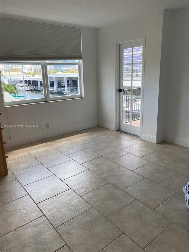 1424 SE 15th St Unit 45, Fort Lauderdale, FL 33316 - tiled empty room featuring healthy amount of natural light and baseboards