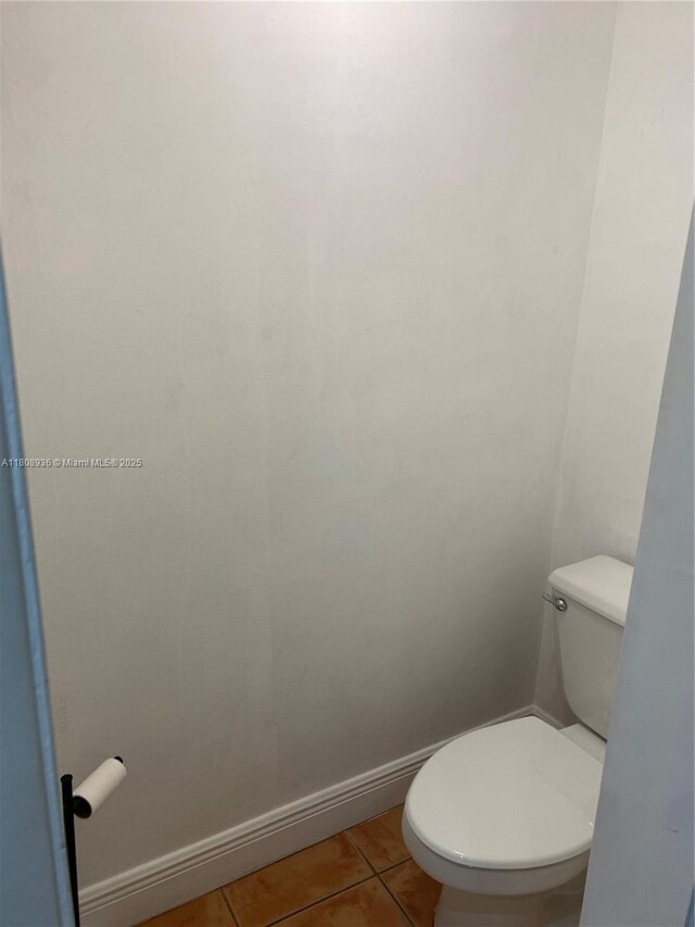 1424 SE 15th St Unit 45, Fort Lauderdale, FL 33316 - bathroom featuring toilet, tile patterned floors, and baseboards