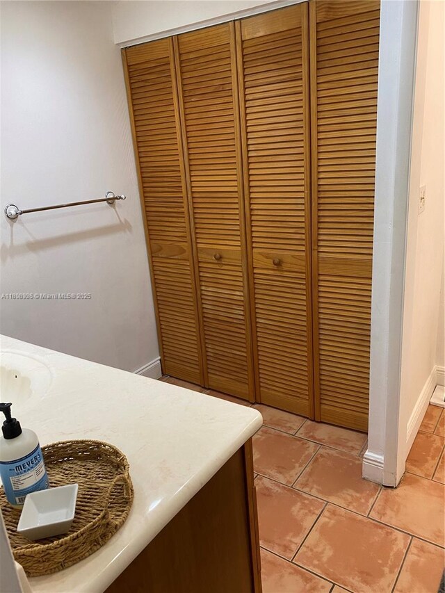 1424 SE 15th St Unit 45, Fort Lauderdale, FL 33316 - bathroom featuring a closet, tile patterned floors, baseboards, and vanity