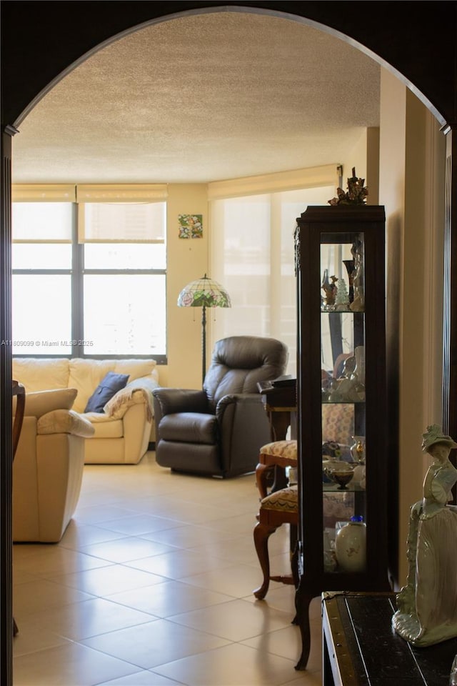 1865 Brickell Ave Unit A2111, Miami, FL 33129 - living area featuring arched walkways, a textured ceiling, and tile patterned flooring