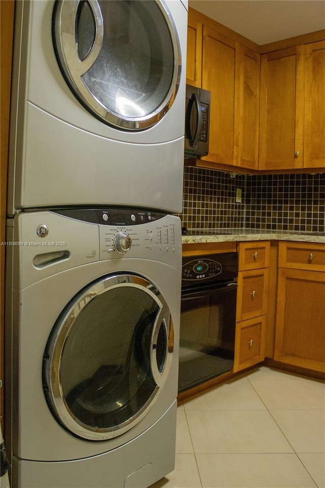 1865 Brickell Ave Unit A2111, Miami, FL 33129 - laundry room with stacked washing machine and dryer and light tile patterned floors