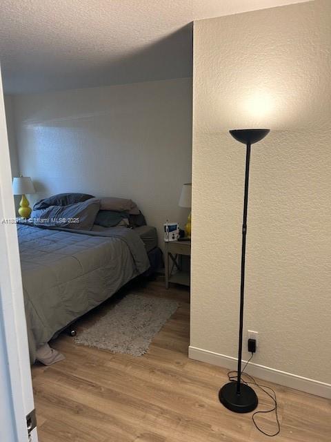 5326 NE 6th Ave Unit E23, Oakland Park, FL 33334 - bedroom featuring light wood-style floors and baseboards