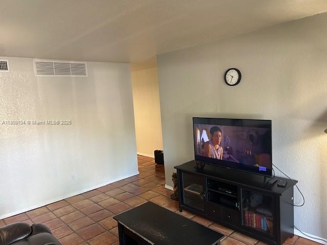 5326 NE 6th Ave Unit E23, Oakland Park, FL 33334 - tiled living room with baseboards