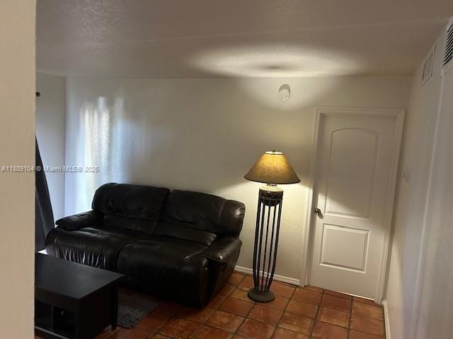 5326 NE 6th Ave Unit E23, Oakland Park, FL 33334 - tiled living room featuring baseboards