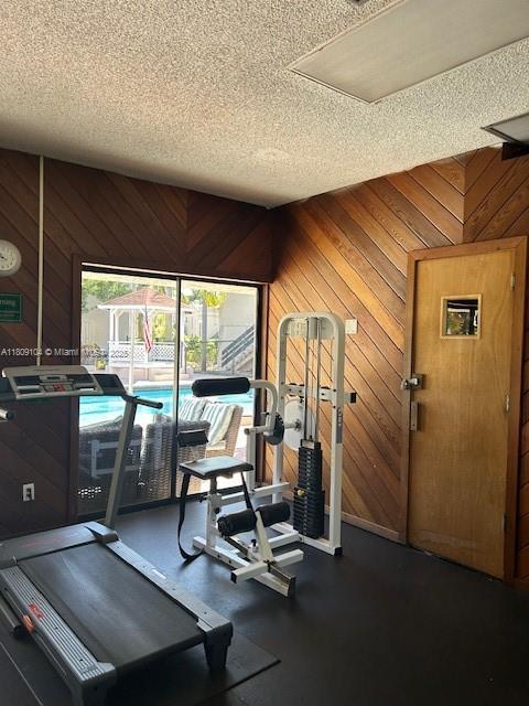 5326 NE 6th Ave Unit E23, Oakland Park, FL 33334 - gym with a textured ceiling and wooden walls