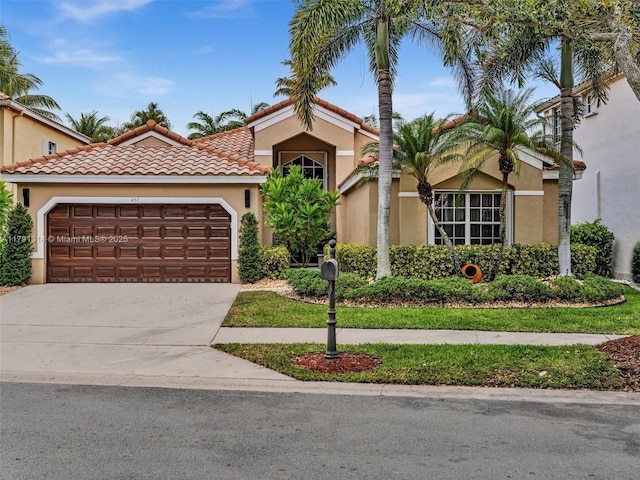 457 Cambridge Dr, Weston, FL 33326 - mediterranean / spanish-style home with a garage, driveway, stucco siding, and a tile roof