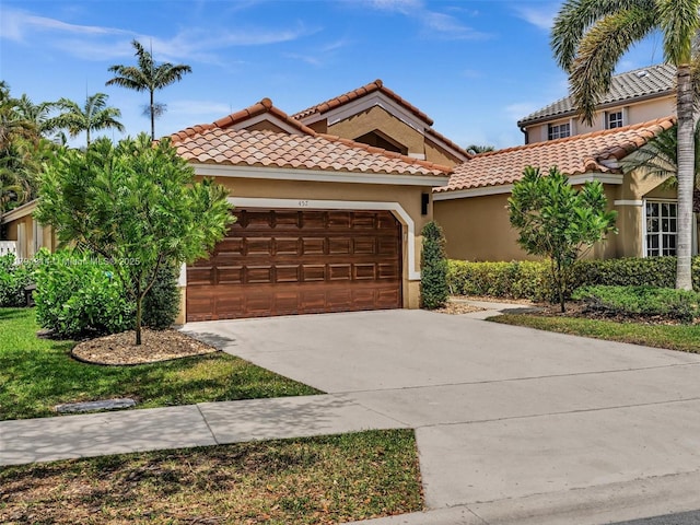 457 Cambridge Dr, Weston, FL 33326 - mediterranean / spanish-style home with a garage, concrete driveway, stucco siding, and a tile roof