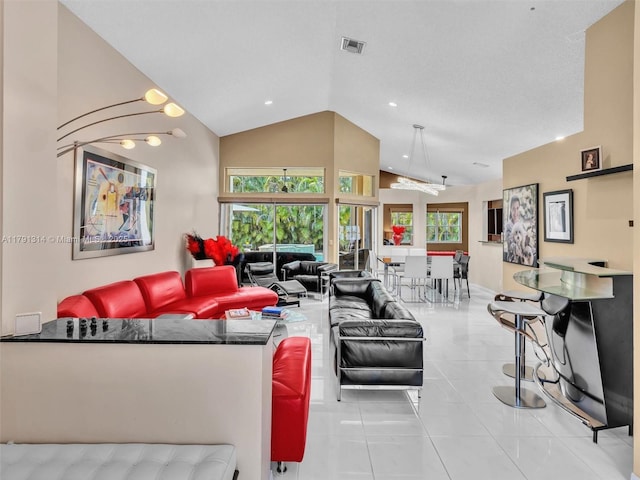 457 Cambridge Dr, Weston, FL 33326 - living area featuring healthy amount of natural light, tile patterned flooring, high vaulted ceiling, and recessed lighting