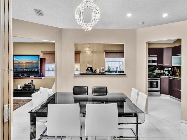 457 Cambridge Dr, Weston, FL 33326 - dining room featuring a chandelier, light tile patterned flooring, a textured ceiling, and recessed lighting