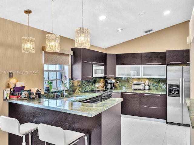 457 Cambridge Dr, Weston, FL 33326 - kitchen featuring stainless steel appliances, a peninsula, vaulted ceiling, decorative backsplash, and a chandelier
