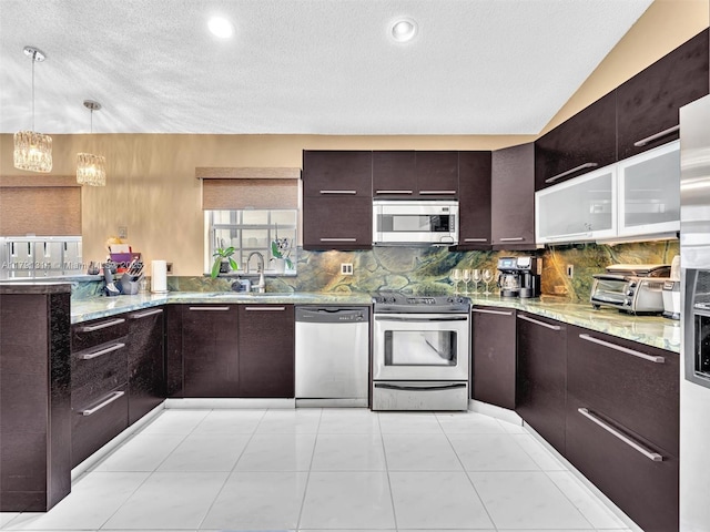 457 Cambridge Dr, Weston, FL 33326 - kitchen featuring stainless steel appliances, backsplash, a chandelier, light stone counters, and a textured ceiling