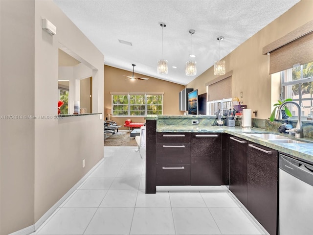 457 Cambridge Dr, Weston, FL 33326 - kitchen with dishwasher, lofted ceiling, healthy amount of natural light, dark brown cabinetry, and light stone counters