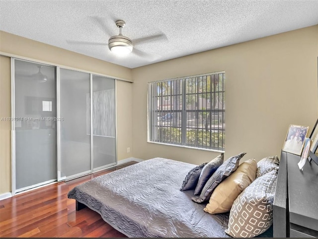 457 Cambridge Dr, Weston, FL 33326 - bedroom featuring wood finished floors, a closet, a ceiling fan, a textured ceiling, and baseboards