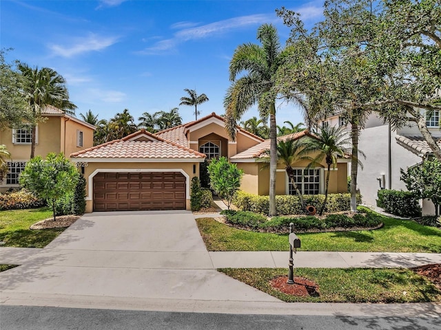 457 Cambridge Dr, Weston, FL 33326 - mediterranean / spanish-style house featuring concrete driveway, an attached garage, stucco siding, a tile roof, and a front lawn