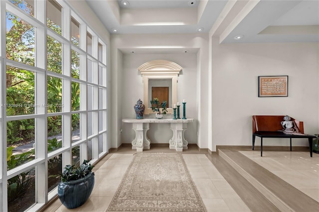 5465 Banyan Trl, Coral Gables, FL 33156 - hallway with tile patterned floors, baseboards, a tray ceiling, and recessed lighting