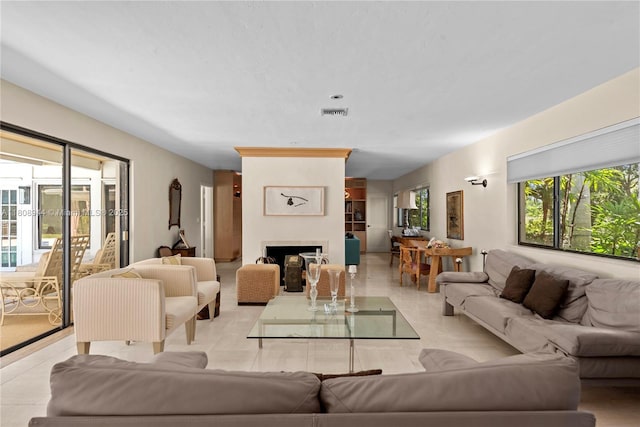 5465 Banyan Trl, Coral Gables, FL 33156 - living area featuring a fireplace and light tile patterned floors