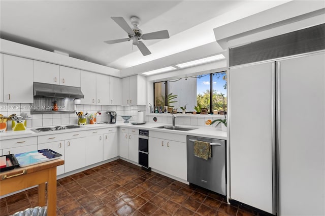 5465 Banyan Trl, Coral Gables, FL 33156 - kitchen featuring paneled built in fridge, stainless steel dishwasher, a sink, under cabinet range hood, and white electric stovetop