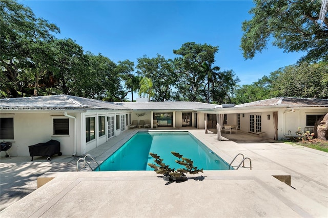 5465 Banyan Trl, Coral Gables, FL 33156 - rear view of house with a patio area, stucco siding, an outdoor pool, and french doors