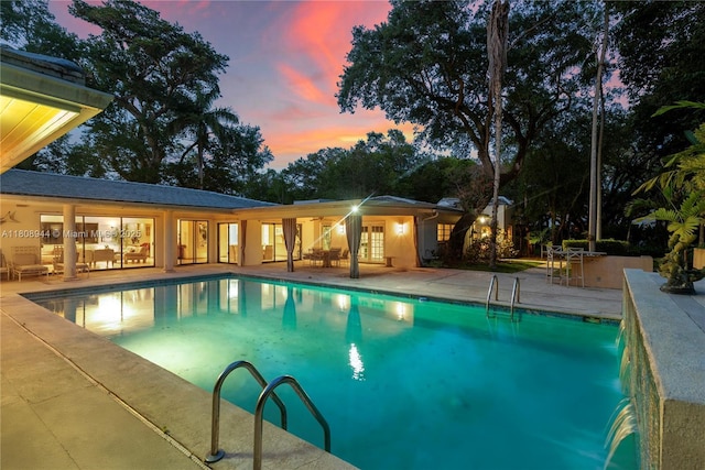 5465 Banyan Trl, Coral Gables, FL 33156 - pool at dusk with an outdoor pool, a patio, and french doors