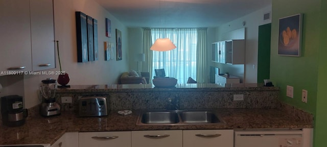 18100 N Bay Rd Unit Ph7, Sunny Isles Beach, FL 33160 - kitchen with dishwashing machine, white cabinetry, and stone counters