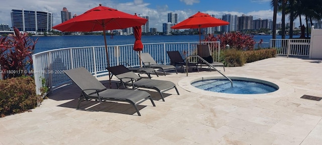 18100 N Bay Rd Unit Ph7, Sunny Isles Beach, FL 33160 - view of pool featuring a skyline view, a patio area, a community hot tub, and a water view