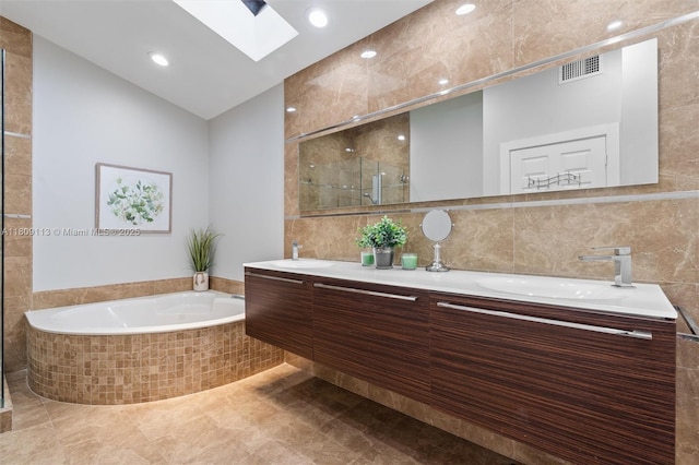 7259 Via Palomar, Boca Raton, FL 33433 - full bath featuring a skylight, double vanity, a bath, a shower stall, and tile walls