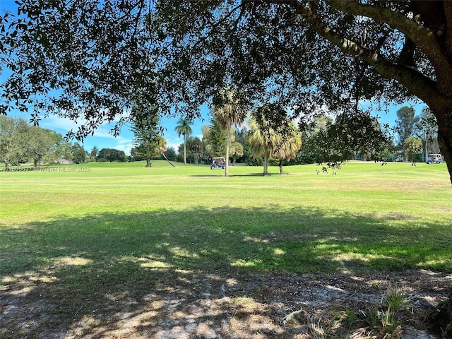 3210 E Medinah Cir E, Lake Worth, FL 33467 - surrounding community featuring a yard