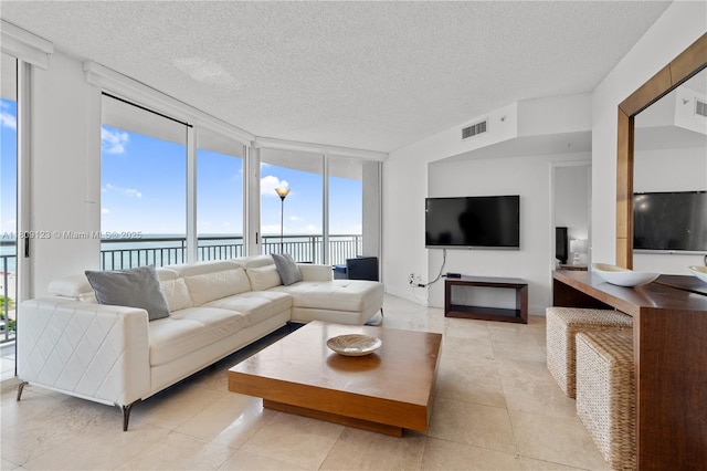 17375 Collins Ave Unit 1108, Sunny Isles Beach, FL 33160 - living area featuring expansive windows, a textured ceiling, healthy amount of natural light, and light tile patterned flooring