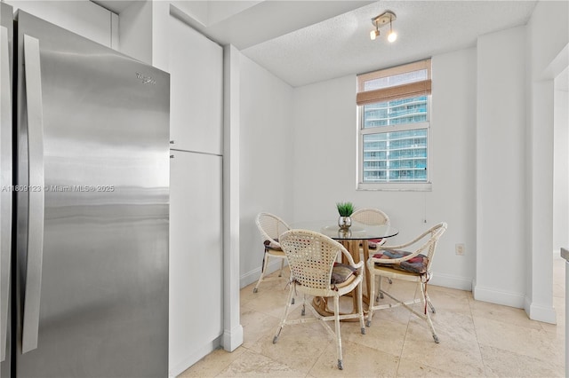 17375 Collins Ave Unit 1108, Sunny Isles Beach, FL 33160 - dining room with baseboards and a textured ceiling