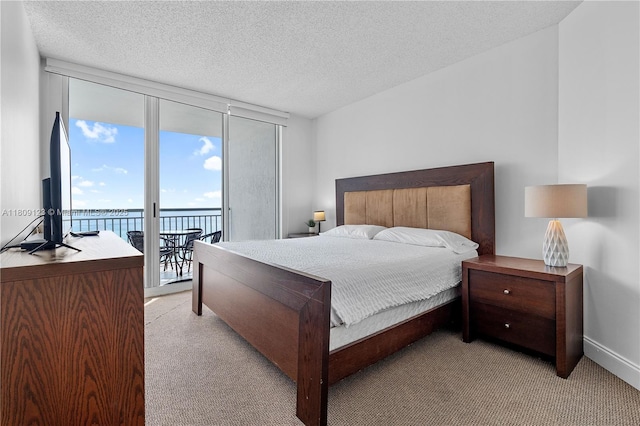 17375 Collins Ave Unit 1108, Sunny Isles Beach, FL 33160 - bedroom featuring access to outside, a wall of windows, light carpet, and a textured ceiling