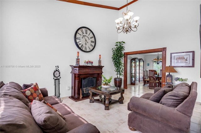 10213 SW 156th Ave, Miami, FL 33196 - living area with a chandelier, ornamental molding, a fireplace with raised hearth, tile patterned floors, and a high ceiling