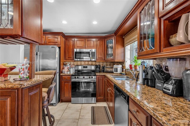 10213 SW 156th Ave, Miami, FL 33196 - kitchen with appliances with stainless steel finishes, light stone countertops, decorative backsplash, recessed lighting, and light tile patterned floors