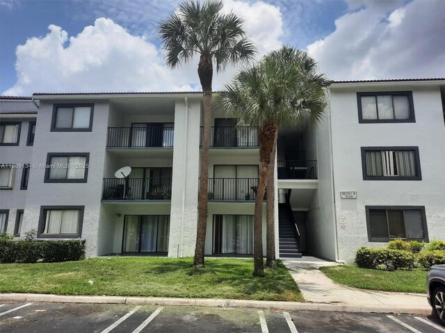 9144 W Atlantic Blvd Unit 832, Coral Springs, FL 33071 - view of building exterior with uncovered parking and stairs