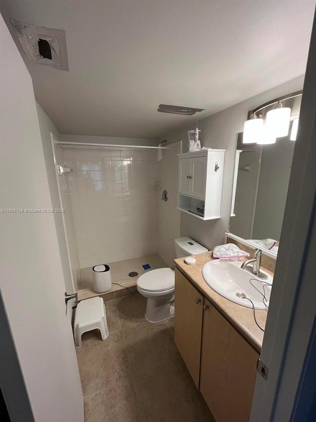 9144 W Atlantic Blvd Unit 832, Coral Springs, FL 33071 - full bath featuring a stall shower, vanity, toilet, tile patterned flooring, and a textured wall