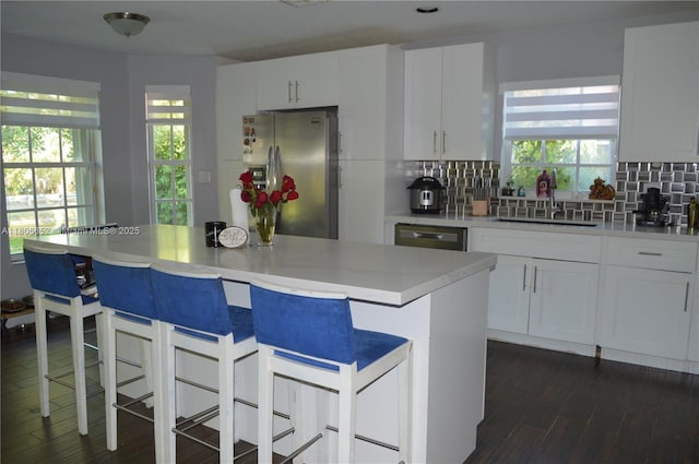 2220 NW 137th Ave, Sunrise, FL 33323 - kitchen featuring appliances with stainless steel finishes, a sink, backsplash, and white cabinetry