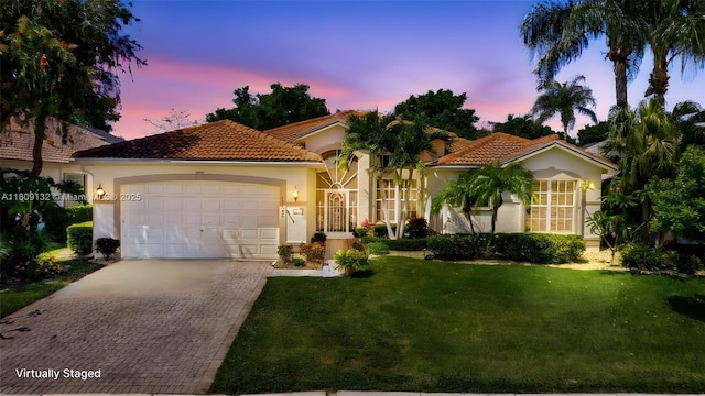11564 Puerto Blvd, Boynton Beach, FL 33437 - mediterranean / spanish house featuring a garage, stucco siding, driveway, a front lawn, and a tile roof