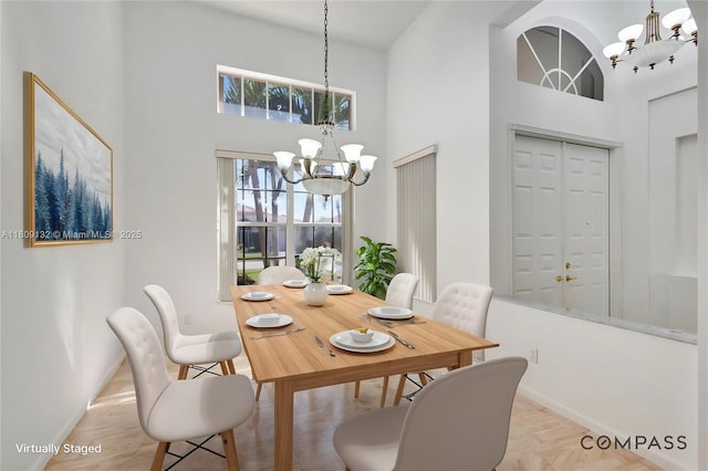 11564 Puerto Blvd, Boynton Beach, FL 33437 - dining space featuring a chandelier, a high ceiling, and baseboards