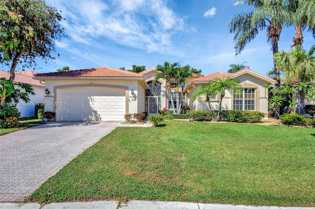 11564 Puerto Blvd, Boynton Beach, FL 33437 - mediterranean / spanish-style house with stucco siding, an attached garage, a tiled roof, decorative driveway, and a front lawn