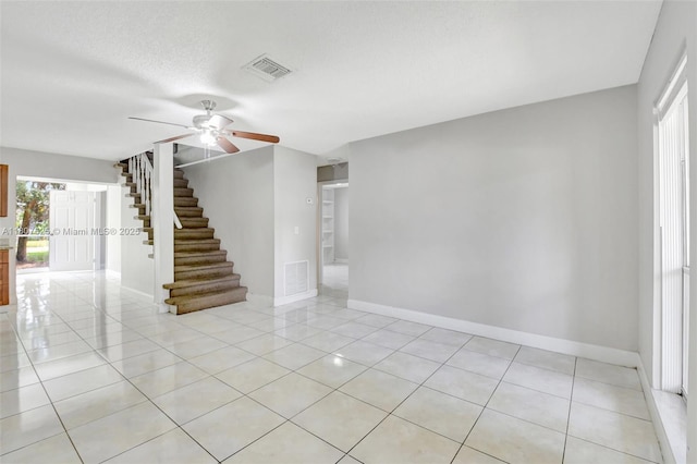 6160 Camp Lee Rd, West Palm Beach, FL 33417 - spare room with stairs, baseboards, a ceiling fan, and light tile patterned flooring