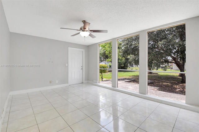 6160 Camp Lee Rd, West Palm Beach, FL 33417 - empty room with ceiling fan, tile patterned floors, baseboards, and a textured ceiling