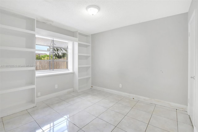 6160 Camp Lee Rd, West Palm Beach, FL 33417 - tiled spare room with a textured ceiling and baseboards