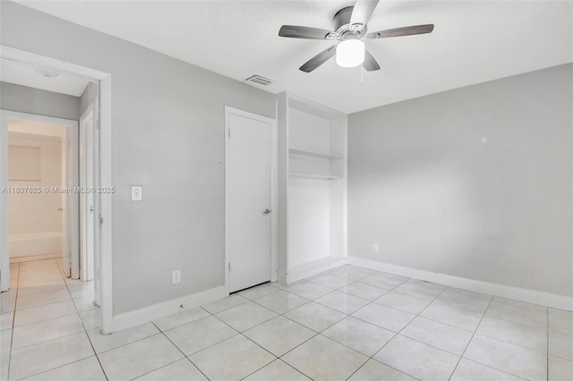6160 Camp Lee Rd, West Palm Beach, FL 33417 - unfurnished bedroom with light tile patterned flooring, baseboards, ceiling fan, and a closet